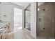 Stylish bathroom with wooden cabinets, a walk-in glass shower, and tile floors at 25224 E Warren Pl, Aurora, CO 80018