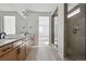 Elegant bathroom featuring a double vanity, framed mirror, tiled shower, and modern fixtures at 25224 E Warren Pl, Aurora, CO 80018