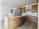 Open kitchen featuring stainless appliances, wood cabinets, and an island with seating, perfect for entertaining guests at 25224 E Warren Pl, Aurora, CO 80018