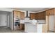 Modern kitchen features stainless steel appliances, a center island, and wood cabinets with white subway tile backsplash at 25224 E Warren Pl, Aurora, CO 80018
