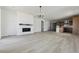Spacious living area features hard surface floors, a cozy fireplace, and an open layout to the modern kitchen at 25224 E Warren Pl, Aurora, CO 80018