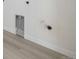 A laundry hook up area in a utility room with light wood flooring at 25224 E Warren Pl, Aurora, CO 80018