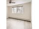 Bright bedroom with large window and wood-look floors at 9335 E Center Ave # 4B, Denver, CO 80247