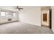 Spacious bedroom with window, ceiling fan and access to hallway at 9335 E Center Ave # 4B, Denver, CO 80247