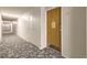 Apartment building hallway with carpeted floors and neutral walls at 9335 E Center Ave # 4B, Denver, CO 80247