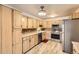 Galley style kitchen with light wood cabinets and stainless steel appliances at 9335 E Center Ave # 4B, Denver, CO 80247