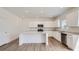 Modern kitchen with white cabinets, stainless steel appliances, and a spacious island at 15276 Fillmore St, Thornton, CO 80602
