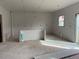 Unfinished kitchen area with space for a center island, natural light, and access to the patio at 15276 Fillmore St, Thornton, CO 80602
