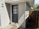 Image of the black back door and the light gray siding that surrounds it at 1967 S Oakland Way, Aurora, CO 80014