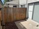 Small back patio with a sliding glass door, a wooden fence and mulch at 1967 S Oakland Way, Aurora, CO 80014