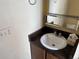 Bathroom sink featuring dark cabinets and a medicine cabinet at 1967 S Oakland Way, Aurora, CO 80014