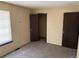 Cozy bedroom featuring neutral walls, carpeted floors, and two closets near a window at 1967 S Oakland Way, Aurora, CO 80014