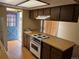 Practical kitchen with essential appliances and a door to the backyard at 1967 S Oakland Way, Aurora, CO 80014