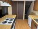 Functional kitchen featuring laminate countertops and stairs leading up to a second floor at 1967 S Oakland Way, Aurora, CO 80014
