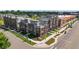 Corner lot townhomes featuring manicured lawns and a sidewalk at 6971 E Lowry Blvd, Denver, CO 80230