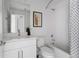 Clean bathroom with white tile, modern vanity, framed art, and shower-tub combination at 6971 E Lowry Blvd, Denver, CO 80230