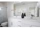Sleek bathroom with double sinks, modern fixtures, and a glass-enclosed shower at 6971 E Lowry Blvd, Denver, CO 80230