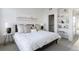 Comfortable bedroom showcasing a plush bed, stylish side tables, and ample natural light at 6971 E Lowry Blvd, Denver, CO 80230