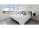Cozy bedroom featuring a comfortable bed, large windows, and modern decor at 6971 E Lowry Blvd, Denver, CO 80230