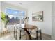 Bright dining area with a modern table, stylish chairs, and a large window at 6971 E Lowry Blvd, Denver, CO 80230