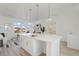 Open kitchen and living space with an island, pendant lighting, and modern decor at 6971 E Lowry Blvd, Denver, CO 80230