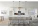 Modern kitchen with a large island, pendant lighting, and stainless steel appliances at 6971 E Lowry Blvd, Denver, CO 80230
