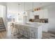 Modern open kitchen with an island, bar seating, and stainless steel appliances at 6971 E Lowry Blvd, Denver, CO 80230