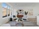 Bright living room featuring modern furnishings, stylish decor, and large windows at 6971 E Lowry Blvd, Denver, CO 80230