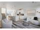 Open concept view of the Kitchen and Living Room area with modern decor and furnishings at 6971 E Lowry Blvd, Denver, CO 80230