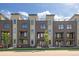 Modern exterior of newly constructed townhomes with multi-level balconies and contemporary design at 6971 E Lowry Blvd, Denver, CO 80230