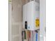 Efficient tankless water heater system with visible piping and connections at 6971 E Lowry Blvd, Denver, CO 80230