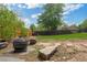 Landscaped backyard featuring a fire pit and a lush lawn, perfect for entertaining at 1590 S Macon St, Aurora, CO 80012