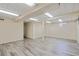 Open basement space featuring modern flooring and natural light from multiple windows at 1590 S Macon St, Aurora, CO 80012