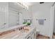 Nicely designed bathroom with vanity, large mirror, updated fixtures, and shower with curtain at 1590 S Macon St, Aurora, CO 80012