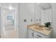 Bright bathroom with vanity, mirror, and view into hall at 1590 S Macon St, Aurora, CO 80012