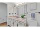 Well-lit bathroom with vanity, granite countertop, updated fixtures, and decorative art at 1590 S Macon St, Aurora, CO 80012