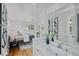 Bright bedroom with en-suite bathroom featuring a single sink vanity and decorative mirror at 1590 S Macon St, Aurora, CO 80012