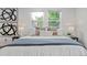 Comfortable bedroom with bright windows, neutral decor, and a cozy king size bed at 1590 S Macon St, Aurora, CO 80012