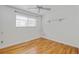 Bedroom featuring hardwood floors, white walls, ceiling fan, and window with blinds at 1590 S Macon St, Aurora, CO 80012