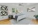 Inviting bedroom with hardwood floors, bright white walls, and ample natural light from three windows at 1590 S Macon St, Aurora, CO 80012