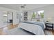 Bright primary bedroom with a ceiling fan, natural light, and mirrored closet at 1590 S Macon St, Aurora, CO 80012