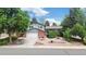 Charming two-story home with lush landscaping, a brick facade, and an attached two-car garage at 1590 S Macon St, Aurora, CO 80012
