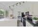 Bright kitchen featuring white cabinetry, and modern appliances at 1590 S Macon St, Aurora, CO 80012