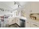 Bright kitchen features white cabinets, tile countertops, stainless steel appliances, and a large window at 1590 S Macon St, Aurora, CO 80012