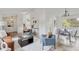 Open-concept living area with hardwood floors, stylish furniture, and plenty of natural light at 1590 S Macon St, Aurora, CO 80012