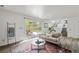 Bright living room with sliding door to the backyard patio and views of the dining area at 1590 S Macon St, Aurora, CO 80012