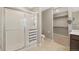 Bathroom featuring a tiled stand-up shower with glass doors and a walk-in closet at 868 N Quatar St, Aurora, CO 80018