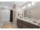 Bathroom showcasing double sinks, a bathtub, and tiled floors at 868 N Quatar St, Aurora, CO 80018