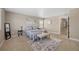 Well-lit bedroom with neutral carpet, a bench at the end of the bed, and a large window at 868 N Quatar St, Aurora, CO 80018