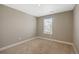 Vacant bedroom featuring neutral colors and a bright window with natural light at 868 N Quatar St, Aurora, CO 80018